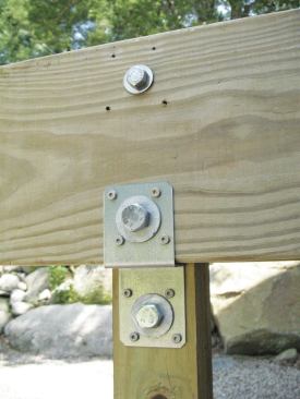On 4x4 posts, metal hardware—including Simpson Strong-Tie’s DJT14Z (shown) and USP’s SDJT14-TZ—can be used to support side-applied beams.
