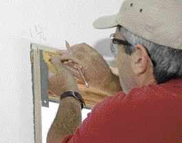 The author marks the 1/4-inch reveals around the perimeter of the window.