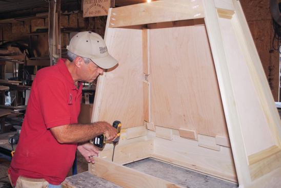 Fastening a pair of cleats alongside the plywood cutout to support the fan liner was the last thing done in the shop.