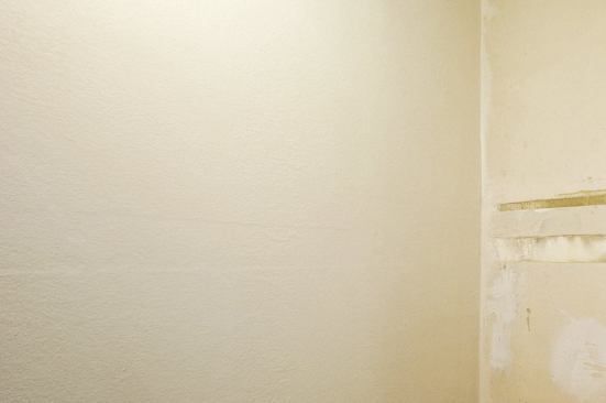 Then, smoothing on a fiberglass mat, and coating it with a top layer of binder.