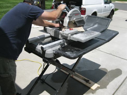 The flap of shower-pan liner material on the front of the saw is not original equipment; the tile setter screwed it onto the blade housing to reduce “overspray” and keep himself dry. It’s not pretty, but it does the job.