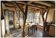 The architect uses small-diameter trees to support structures from the interior, permitting large daylight openings.