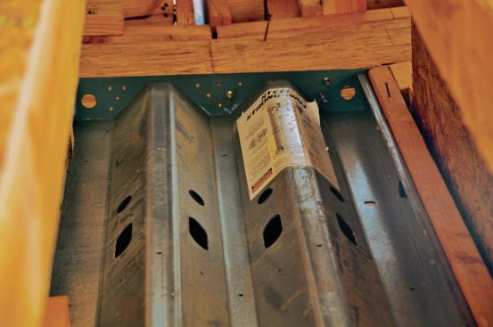 At the top of the panel by contrast, the connection consists only of Simpson SDS screws—lighter-duty fasteners.