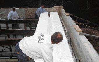 The 24-foot-long panels were shortened to bear only on the inner edge of the foundation forms. A recip saw was used to cut through the integral steel Z-beams.