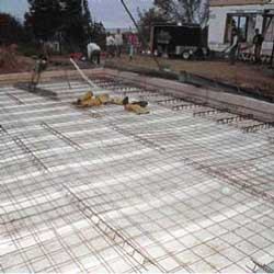 Welded 6-inch-square steel fabric was placed over wire chairs and wire-tied to the perimeter rebar to unify the floor system.