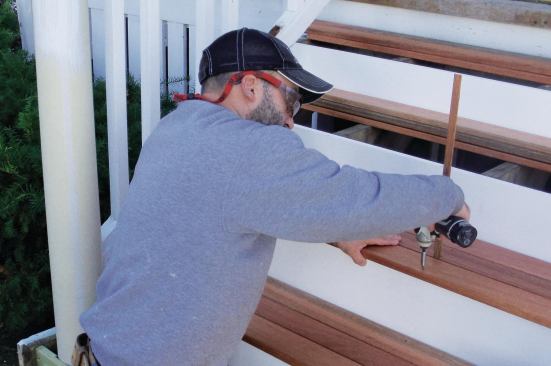 Mahogany 1x4 treads were secured with trimhead stainless steel screws. The vertical wooden strip spaced the treads consistently.