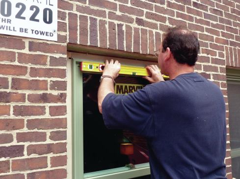 Slip the full-frame replacement sash into the opening. If the sill of the buck was installed level, shimming should not be necessary. Check the head jamb for level, shim if necessary.