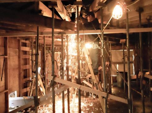 New steel beams were passed in through an opening in the outside wall (visible at lower left), raised into position, and welded together.