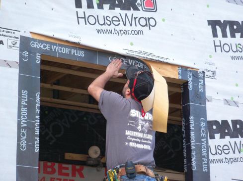 To prevent window leaks — along with the mold growth, rot, and callbacks from irate clients that go with them — the author has developed a "bombproof" method of keeping window openings reliably watertight. Here, the head flashing is being applied, but the process starts with planning, precutting flashing strips, and applying them from the rough sill and working upward along the side jambs to the header.