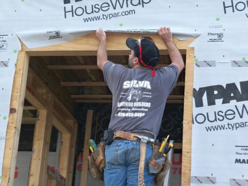 At the head of the rough opening, cut a flap of house wrap as shown and tuck it up out of the way.