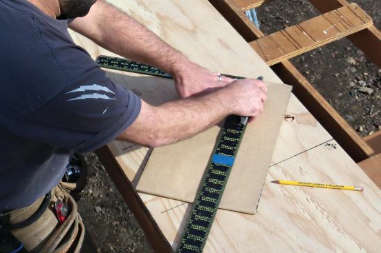 Trim the flashing material with a utility knife using a framing square for a guide.