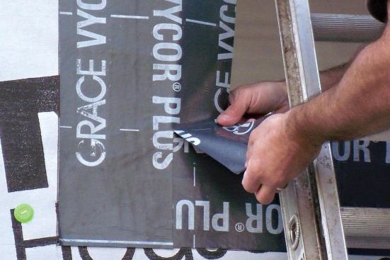 Cut slits at the bottom and top of the opening to create a flap. Fold it into the opening against the rough jamb.