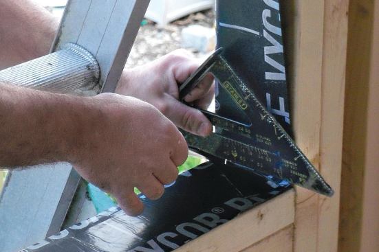 Press the side flashing flap into the bottom and top corners as shown.
