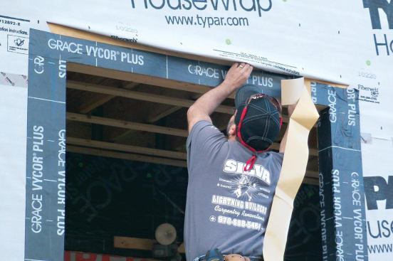 Apply the head flashing flush with the outer edge of the rough header.