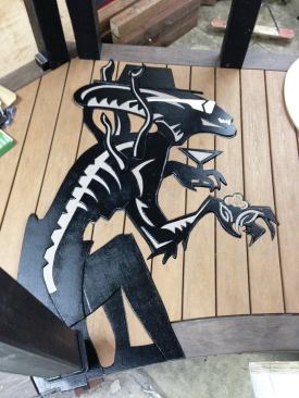 The author crafted an inlay of an "Alien" Xenomorph sporting sunglasses and a drink.