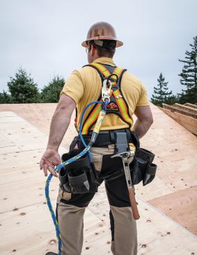 The full body harness (superanchor.com) has multiple D-rings, integral tool bags, and a hammer holder, and comes in different sizes. Here it’s connected to Super Anchor’s X-Line, which combines a 50-foot safety line with a pneumatic air hose.