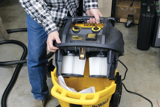 The DWV012 contains two self-cleaning HEPA filters and can be used with or without a collection bag. Bags are for the convenience of the operator, to make it neater and easier to dispose of debris. Shown here with a fleece bag in the tank, the machine also accepts paper collection bags and open-top plastic tank liners.