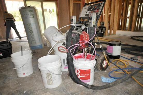 A proprietary spray rig is used to apply flexible latex foam to potential leak points between framing members,