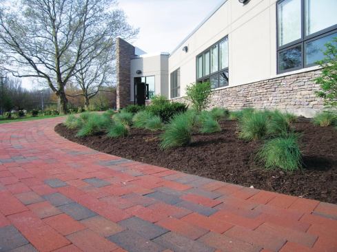 Seams in a running-bond pattern are offset by a half-brick. As seams “catch up” to each other on curves, inserting a cut paver resets the pattern.