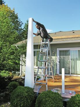 To conceal the rough edges of the panels, 1-by trim is nailed into a bed of caulk at each of the corners.    