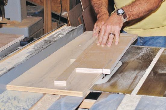 To safely cut the tapered 3/4-inch plywood panels, I made a plywood sled for the table saw and used the drop from the first angled cut as a spacer for cutting the remaining edges.