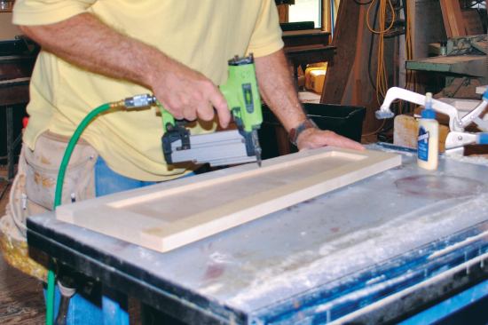 I applied yellow glue to the rabbets, dropped the panels in place, and secured them with headless pins while the glue dried.