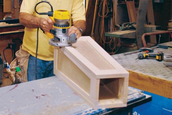 Setting the two wider frames slightly proud of the two narrower frames made it easier to flush-trim the joints with a router after the glue dried; this resulted in better-looking joints. I cleaned up the 26-inch-high assembly with a random-orbit sander and 120-grit paper.