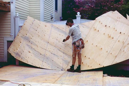 After scribing the stair on the plywood on the ground, the author makes a mirror image of the layout from a double layer of plywood, adding 3 1/2 inches — a stud width — to both edges.