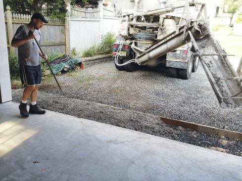 The apron slab was reinforced with wire mesh and sloped down toward the driveway 1 inch over its 4-foot width.
