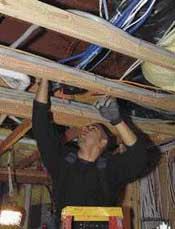 If structured wiring has to cross high-voltage wiring, the two types of wire should cross at a 90-degree angle to minimize interference. In this case, the low-voltage cables above the joists are perpendicular to the household electrical wire that runs along the sides.