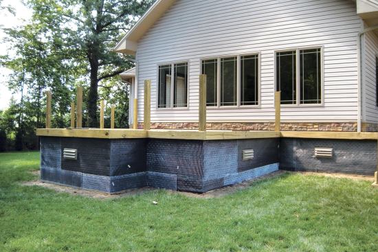 The metal lath was installed atop a weather-resistant barrier. A scratch coat and stone fascia will cover it completely.