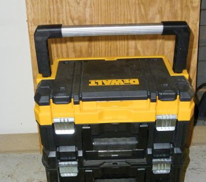 Due to the size of its handle, the Long Handle Tool Case must be on top. DeWalt recommends against lifting more than three boxes at a time.
