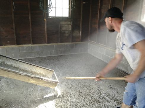Then they poured the new 4-inch slab flush with the top of the footing. The fiberboard serves to isolate the slab from the footing should any frost issues arise.