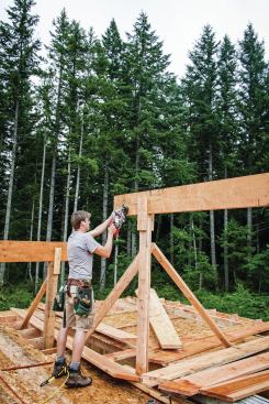 I like to leave the ridge a few inches long, and set one pair of kings and hips on one end of the building to lock in the ridge. Then, on the other end of the ridge, I use the plumb cut at the end of a king common to mark the length of the ridge, and cut it off in the air.