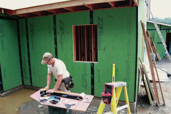 For the windows, we set up a mobile cutting station to cut tape for the head, jamb flashing, and the four-piece pan.