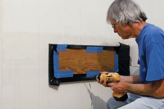 When plaster washers don’t provide enough clamping pressure, fasten plastic-covered 3/4-inch plywood over the glued area until the adhesive has cured.