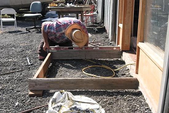 Use a level on the forms to ensure the slab is level. If the slab is to be pitched, tape a shim to one end of the level to account for the desired slope.