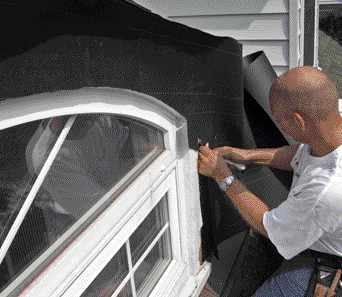 Using two pieces of 30-pound felt and a utility knife, the author makes a template of the existing dormer trim.

