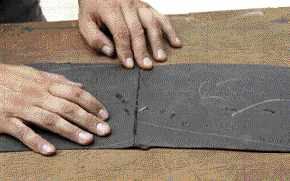 The author reassembles the two felt-paper sections using the plumb cut.