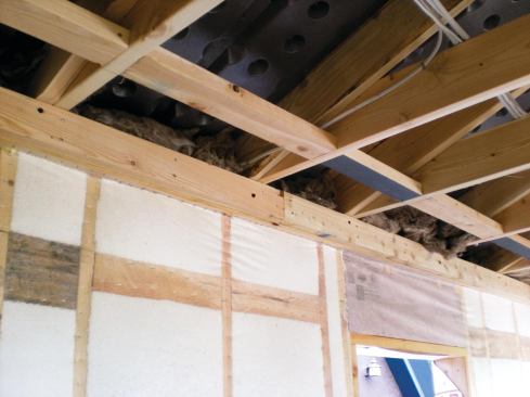 To provide a solid attachment point for the prefabricated arches, the author installed rows of blocking between the wall and ceiling framing. The blocking is centered 12 inches from the wall/ceiling intersection, and also provides good backing for drywall.