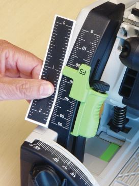 To adjust the cutting depth, you simply press the green spring-loaded depth stop and slide it up or down the scale. The scale shows the cutting depth with and without the track. It’s metric, but a peel-and-stick imperial scale comes with the kit.