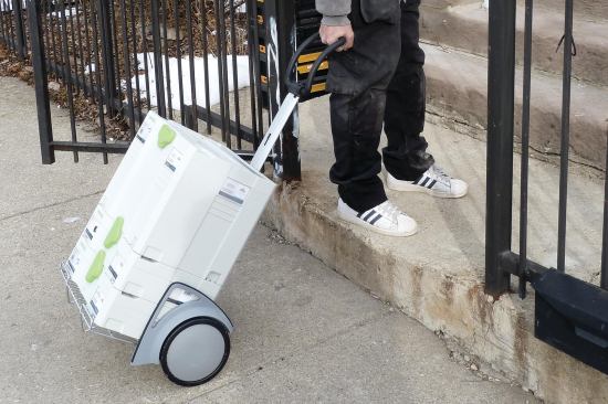 We particularly like Tanos' Folding Trolley. The large wheels roll easily over rough terrain, and it folds flat (5 inches thick) when not in use