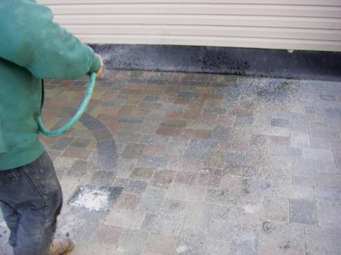 Though it should be installed in bone-dry conditions, wetting polymeric sand in place initiates a reaction that turns it into a flexible mortar. On some materials, however, it can leave a visible haze.