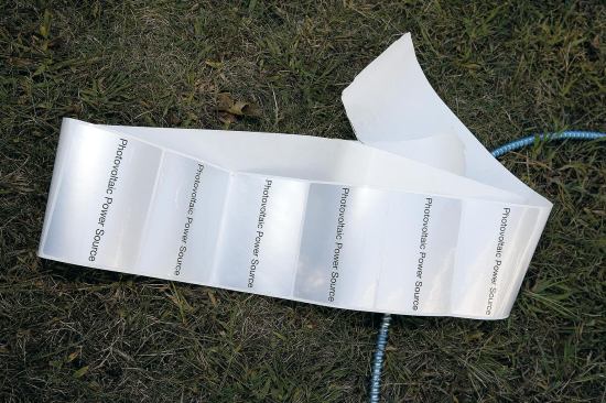Adhesive stickers identifying the cable as a photovoltaic power source will be attached to the cable at regular intervals, as required by code.