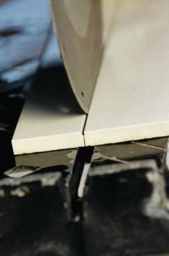 AVOIDING A BROKEN KERF 

A common problem when cutting tiles is a broken kerf, which occurs when the tile breaks apart before the blade finishes a cut. This leaves a bump on one or both sides of the cut at the end of the kerf (7). This lip may not be a problem on a floor installation, but on wall installations where spacers are typically used, it can cause misalignment of the tiles. To maintain a completely smooth kerf, slow down the rate of feed as the blade exits the cut, and hold both sides of the tile firmly against the cutting table (8).