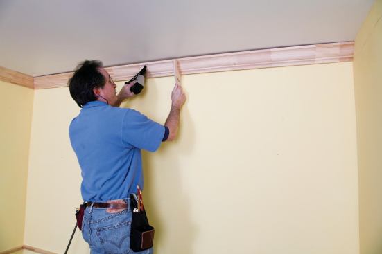 The author fastens only the right half of that piece so that it can be flexed away from the wall when the last piece slips in.