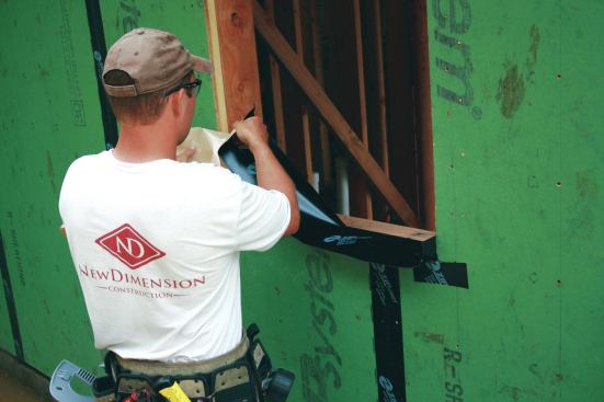 Burnish the tape with the corner/valley tool, including the 2-inch vertical legs, then peel back the other half and adhere it to the sill and trimmer.