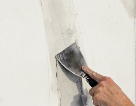 Then fill it with a setting-type joint compound. Cover the filled crack with fiberglass tape and skim it with another layer of compound, then wipe it clean with a drywall knife. Use ready-mix compound for finish coats.