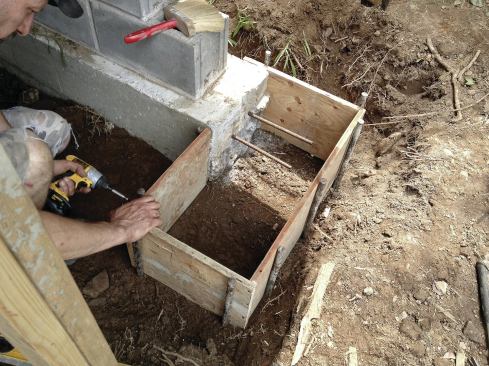 Like the rear footing, the front wall footing returns were pinned to the new gable-end footings with two #5 rebars.