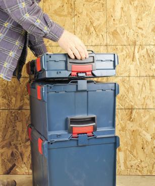 You stack boxes so they align, push down on top, and the spring-loaded clips latch on to the box below.